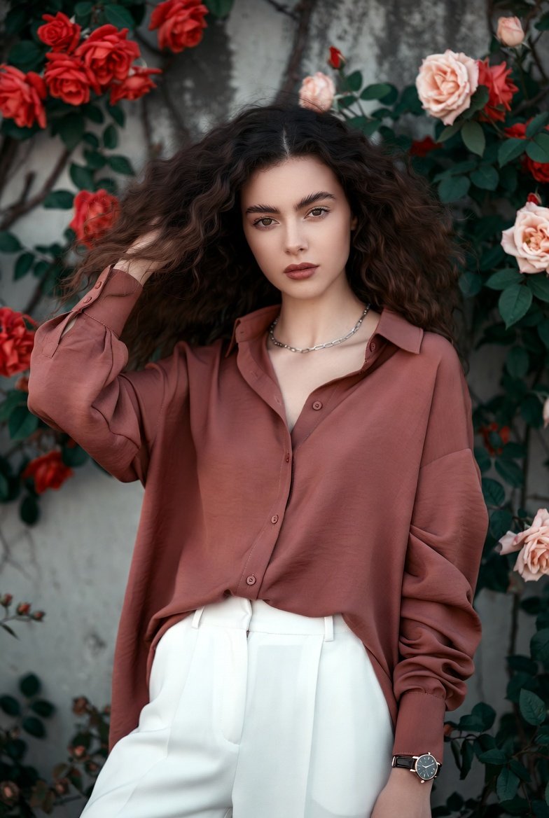 Contrast of Natural Beauty and Industrial Texture in a Young Woman's Full-Body Portrait