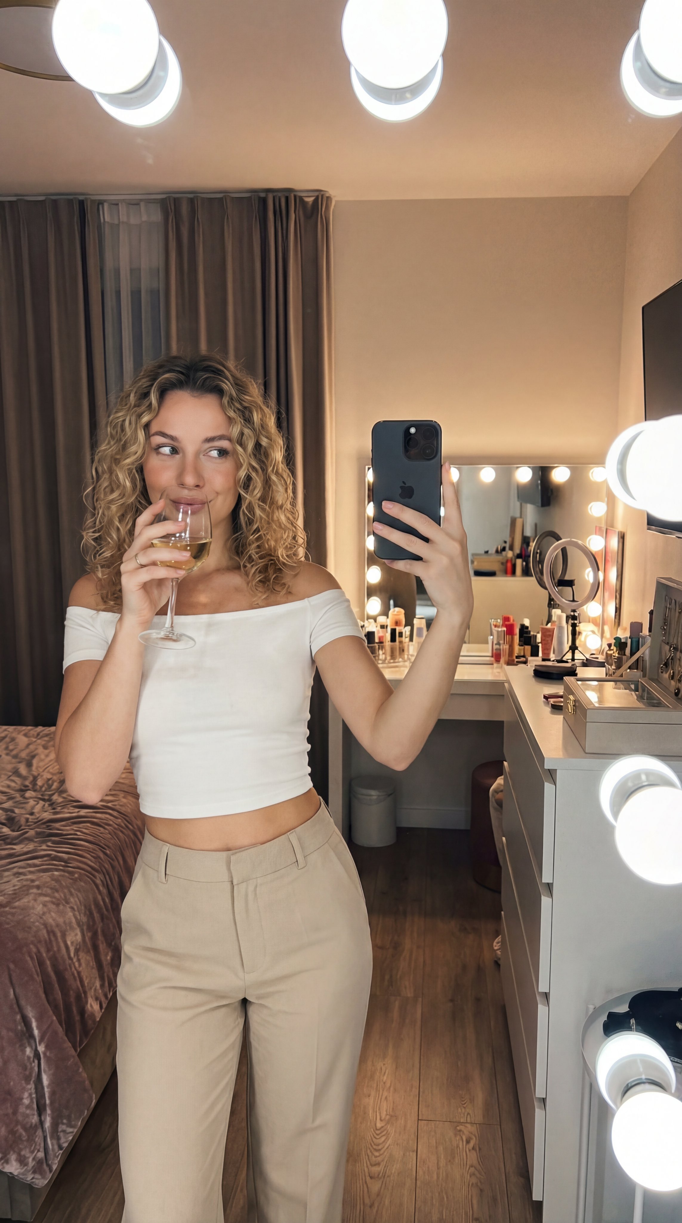 Young Woman's Mirror Selfie in Modern Bedroom